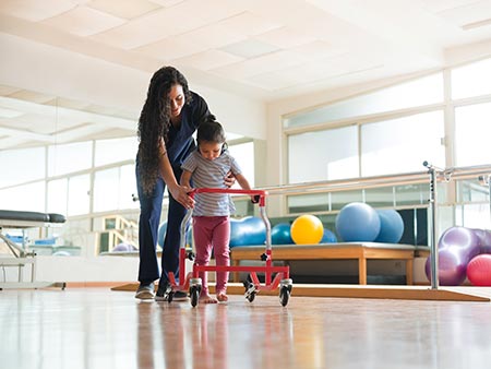 Physiotherapist working with small child