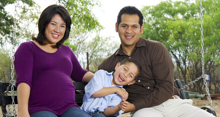 two adults and a child smiling