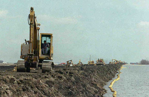 Machines working on the West Dike during the flood of 1997