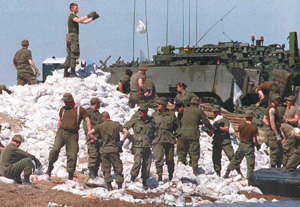 Soldiers tossing sandbags during the flood of 1997