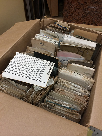 photo of an open cardboard box containing files